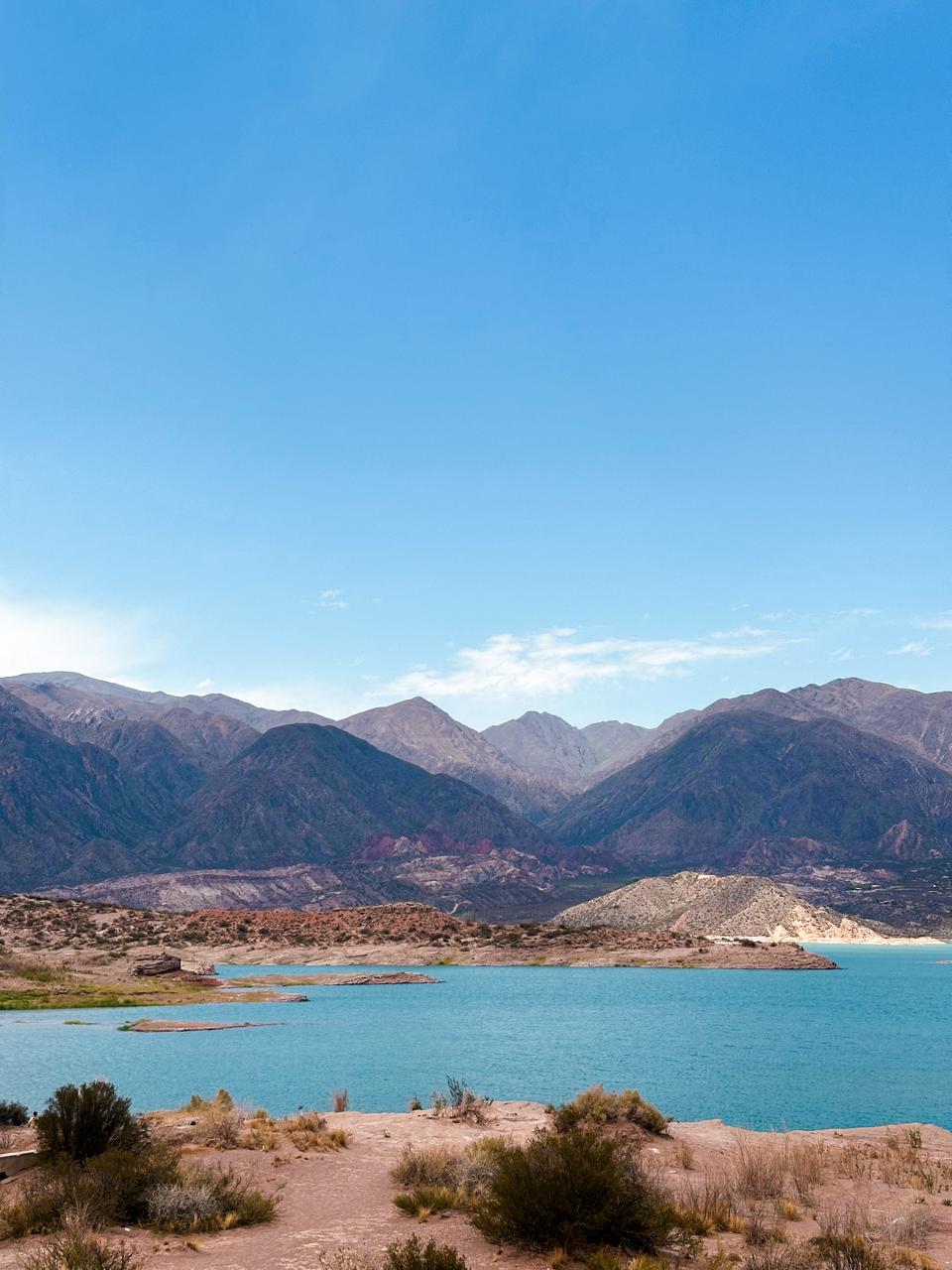 The turquoise water of the Potrerillos reservoir below the mountains near Mendoza
